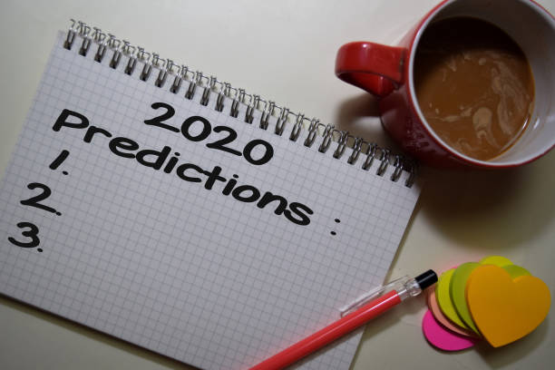 istock 2020 Predictions write on a book isolated on Office Desk. 1211291944