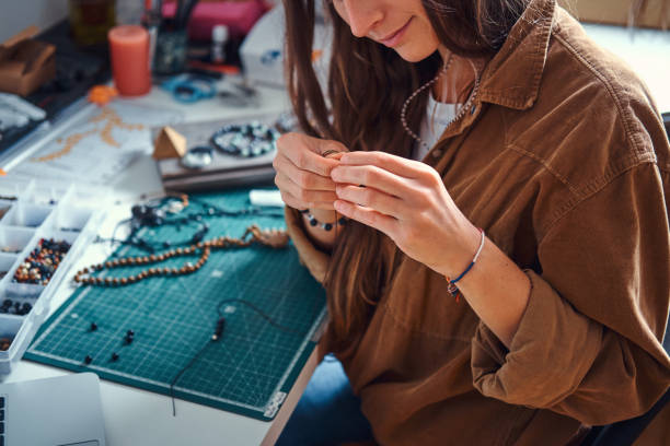 istock Girl is making new beaded jevellery 1211292070