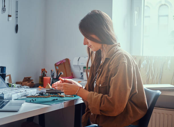 istock Girl is making new beaded jevellery 1211292130