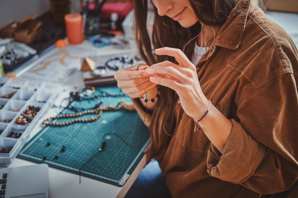 istock Girl is making new beaded jevellery 1211292248