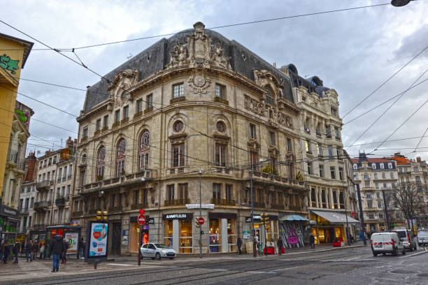 Saint-Etienne, France - January 27th 2020 : Superb building, 1880 style, installed at the corner of a street in the city center. You can see the tram tracks on the street.