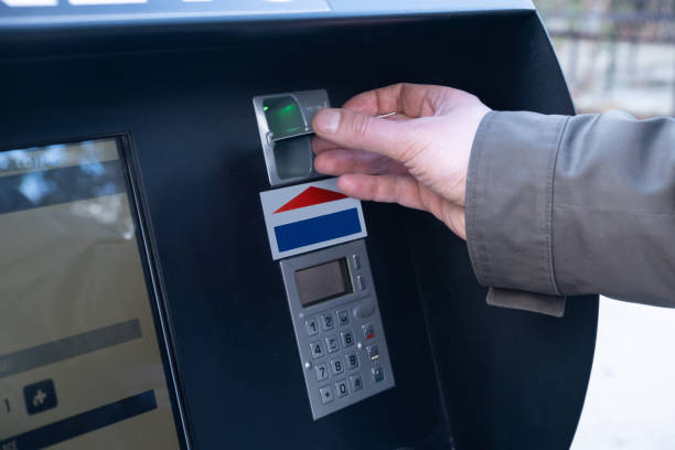 istock A man inserts a credit card into an ATM 1211296014