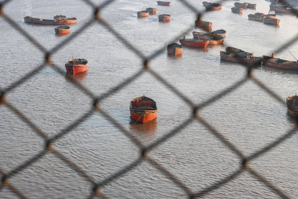 BLURRED BOATS BESIDE RAILING WITH MAGNIFICENT BACKGROUND