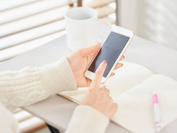 istock Woman operating a smartphone 1211299282
