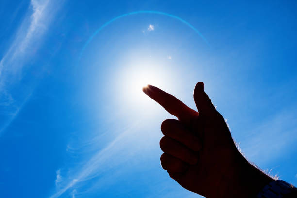 istock Silhouetted hand covering the bright midday sun 1211300011