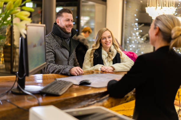 istock smiling wealthy guests at hotel reception 1211300084
