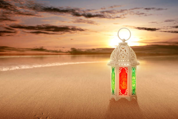 istock Arabic lamp with colorful light on the sandy beach 1211301024