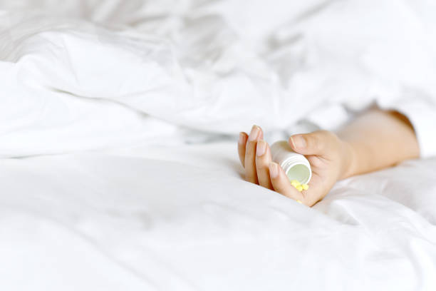 istock Suicide committing by drug overdose, Depressed woman suffer from insomnia problem and sleeping pills addiction abuse. 1211304247