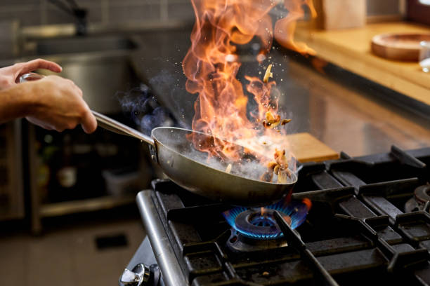 istock Flambing detail with a pan in a professional kitchen 1211304466