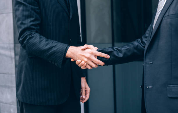istock Group of Business People Shaking Hands with Partnership while Standing with Colleagues after Finish a Meeting Negotiation, Teamwork Concept 1211304591