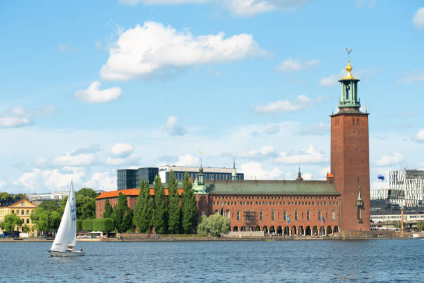 Scenic summer view of the City Hall castle in the Old Town Stockholm Stockholm, Sweden - August 2, 2019: Scenic summer view of the City Hall castle in the Old Town (Gamla Stan) and a yacht on the water kungsholmen town hall photos stock pictures, royalty-free photos & images