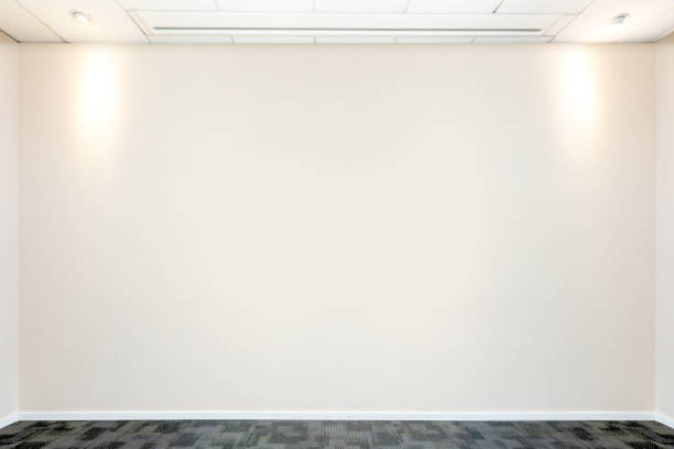 istock Meeting room with lights and empty wall 1211307389