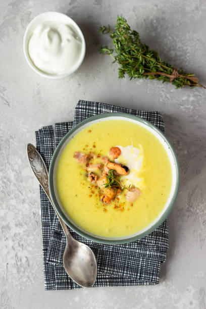 istock Thick milky chowder soup with seafood served with sour cream, thyme and pepper. Light grey stone background. Top view. 1211307735