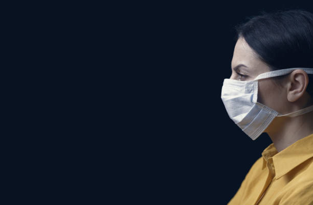 istock Woman wearing a surgical mask 1211309908