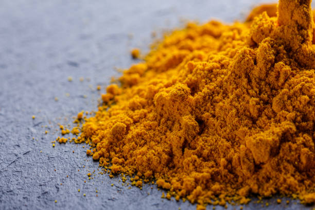 istock natural turmeric powder on a dark stone background 1211310776