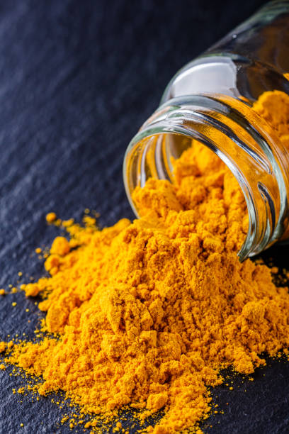 istock natural turmeric powder on a dark stone background 1211310785
