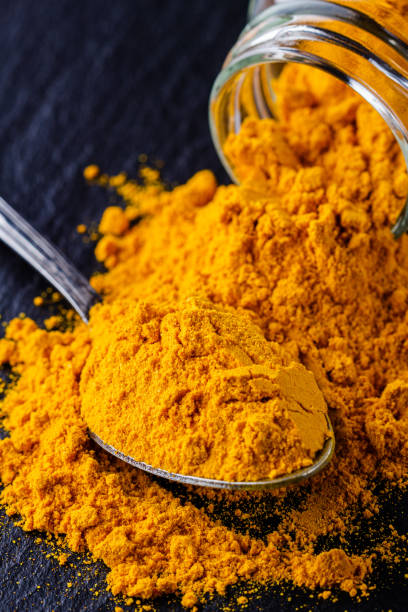 istock natural turmeric powder on a dark stone background 1211310862
