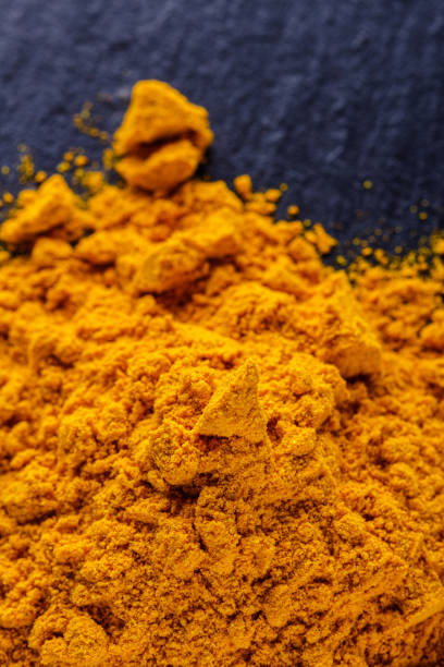 istock natural turmeric powder on a dark stone background 1211310886