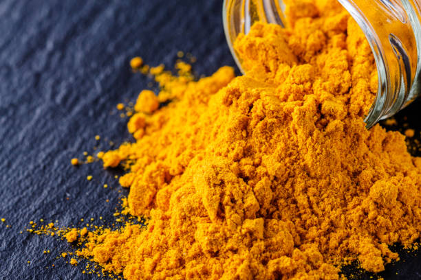istock natural turmeric powder on a dark stone background 1211311074