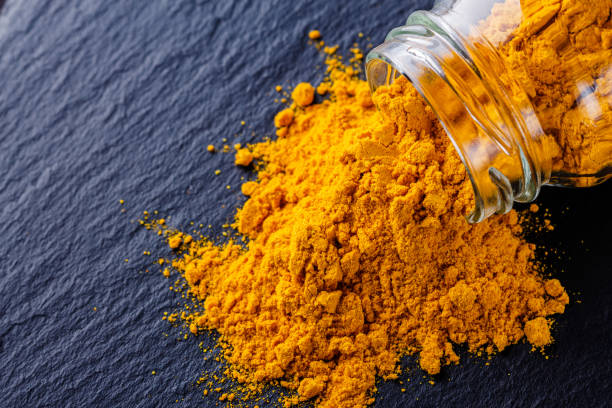 istock natural turmeric powder on a dark stone background 1211311178