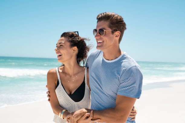 istock Young couple hugging at seaside 1211311822