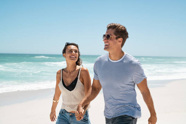 istock Couple enjoying summer vacation on beach 1211311831