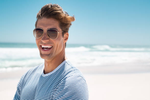 istock Happy laughing man at beach 1211312451