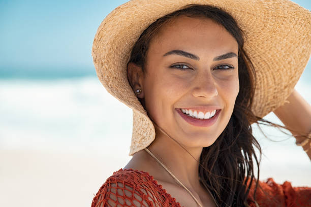 istock Beautiful girl with straw hat at beach 1211312508