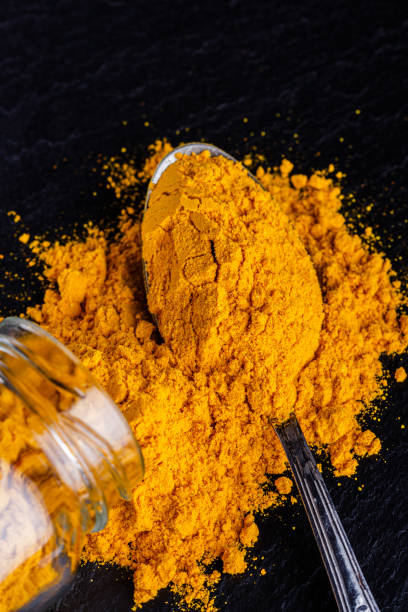 istock natural turmeric powder on a dark stone background 1211312517