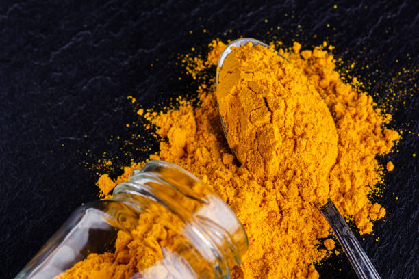 istock natural turmeric powder on a dark stone background 1211312627