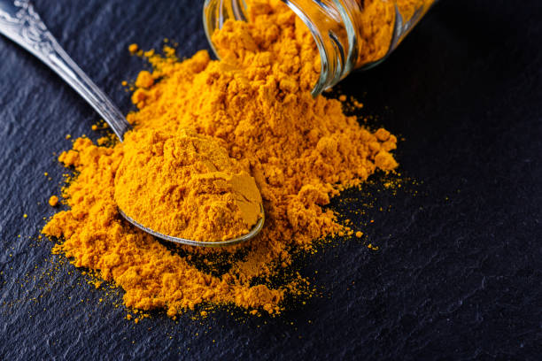 istock natural turmeric powder on a dark stone background 1211312756
