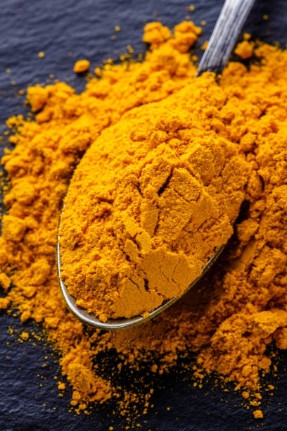 istock natural turmeric powder on a dark stone background 1211312758