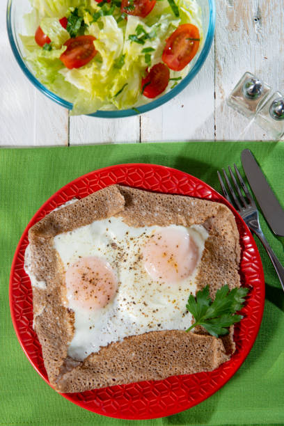 istock homemade Breton crepe with egg in a red plate 1211312886