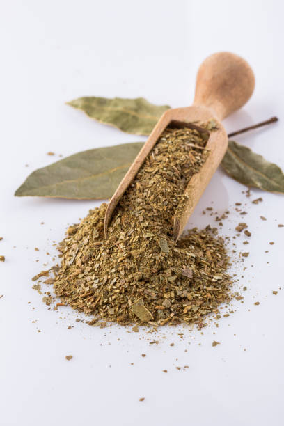 istock ground dried bay leaf on white acrylic background 1211312887