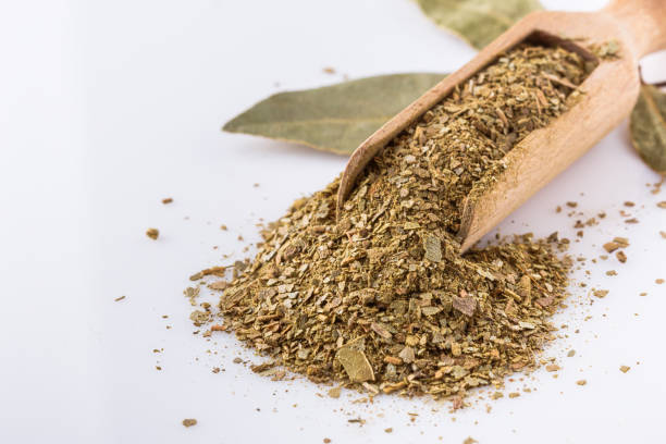 istock ground dried bay leaf on white acrylic background 1211312912