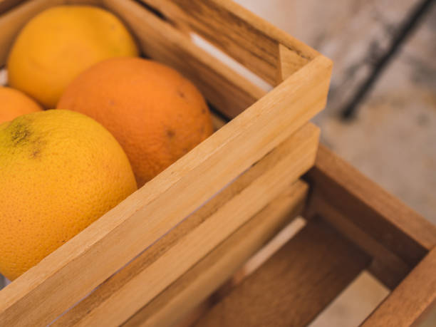 istock Blurred background of fresh oranges in a wooden box. 1211313249