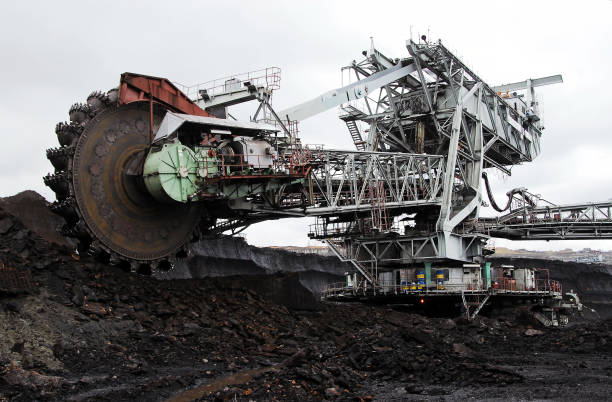 istock Bucket-wheel excavator during excavation at the coal surface mine. Huge excavator on open pit mine. 1211314779