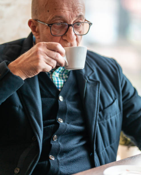 istock Pensive senior man having a coffee indoors 1211315222