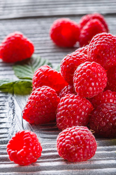 istock juicy fresh natural raspberries on a gray wooden rustic background 1211315899