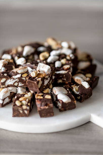 istock homemade chunks of chocolate bites topped with nuts and marshmallows 1211315976