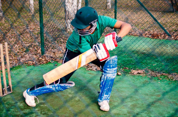 istock Stroke of Cricket Practice Pitcher player behind the nets 1211316929