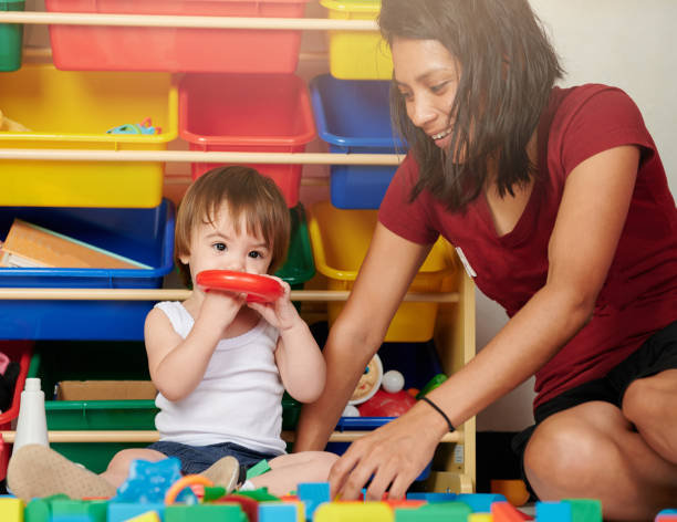 istock Babysitter and kid play together 1211318165