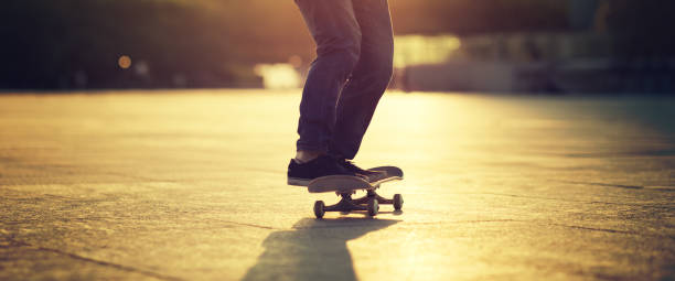 istock Skateboarder skateboarding at sunset city 1211318209