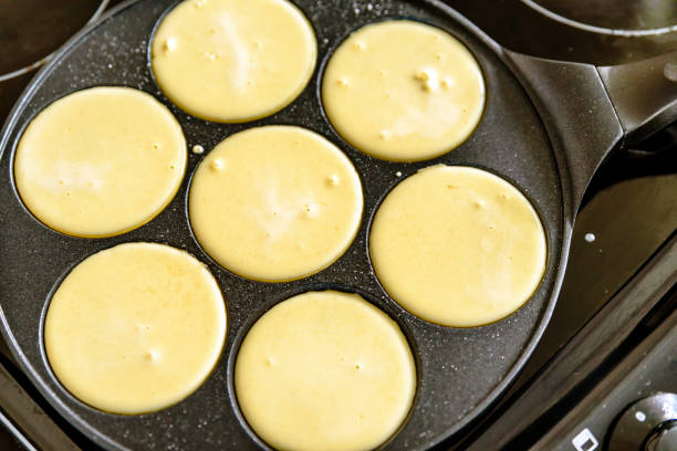 istock pancake frying pan with smile face pancake cooking on cooker in kitchen 1211318262