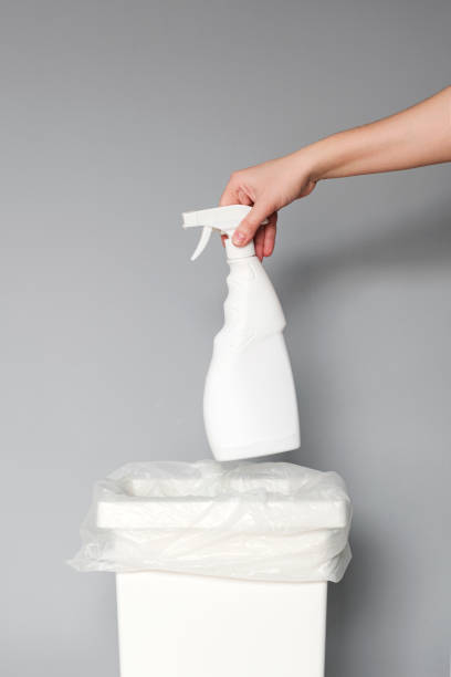 istock A hand puts an empty white plastic bottle of cleaning products in a recycling bin. 1211318793
