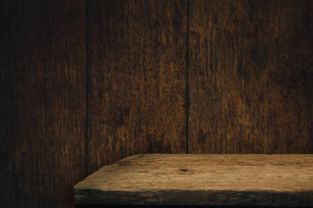 istock Old oak Wooden table and brown wood background wall. 1211319331