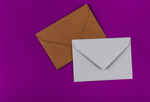 istock Colorful envelopes on a purple background. 1211320200