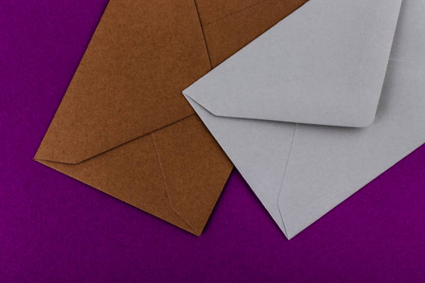 istock Colorful envelopes on a purple background. 1211320202