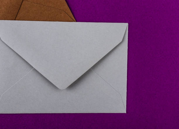 istock Colorful envelopes on a purple background. 1211320222