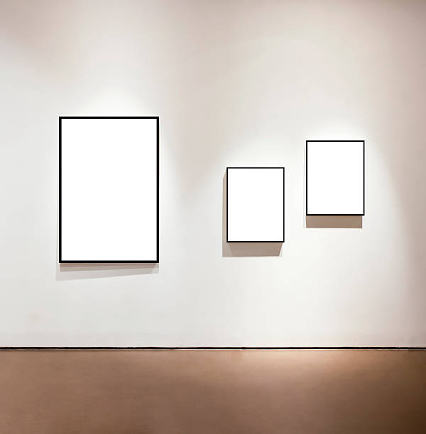 blank frames on the wall at art gallery - museum wall stockfoto's en -beelden